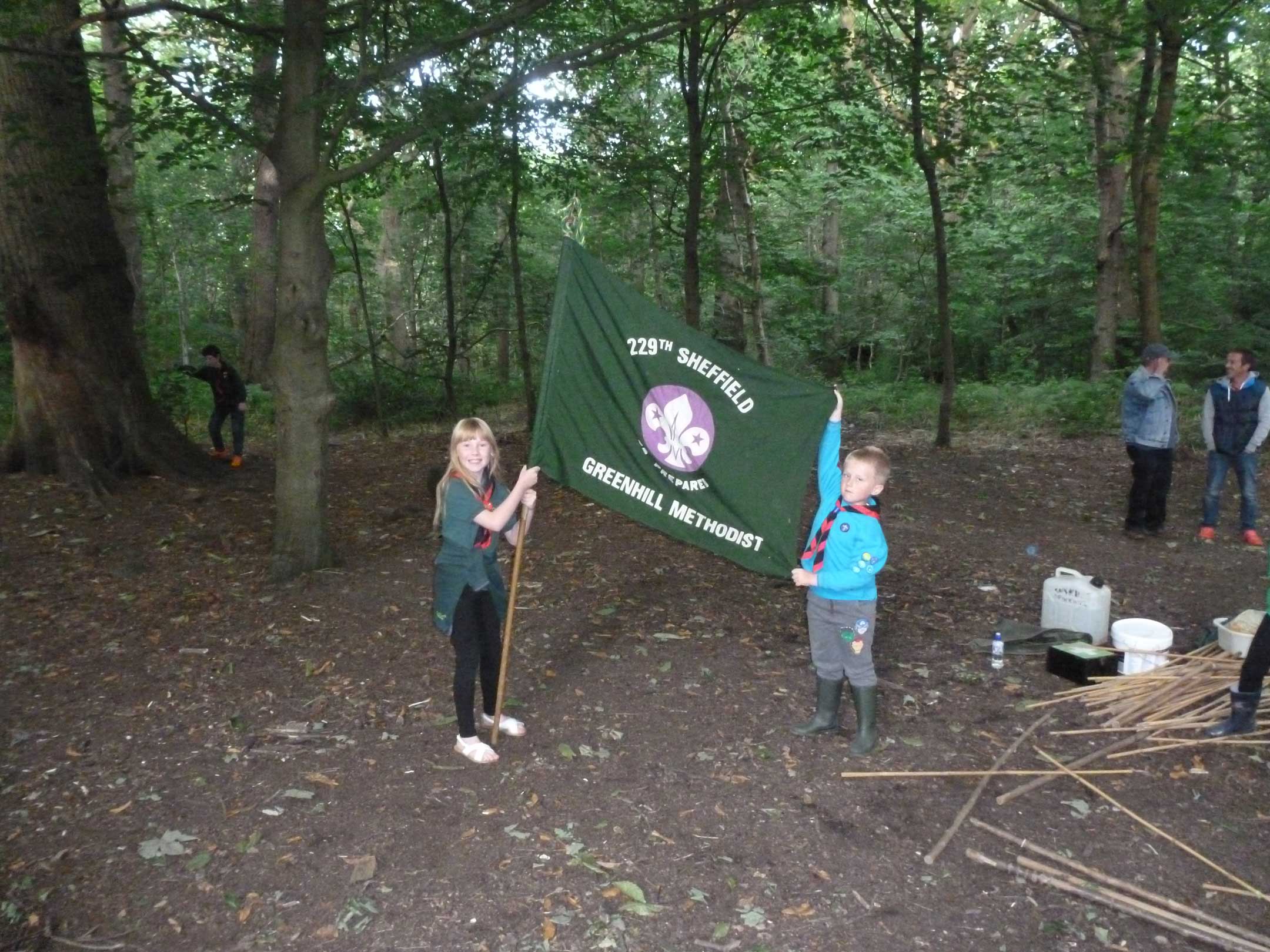 Two cubs holding scout flag
