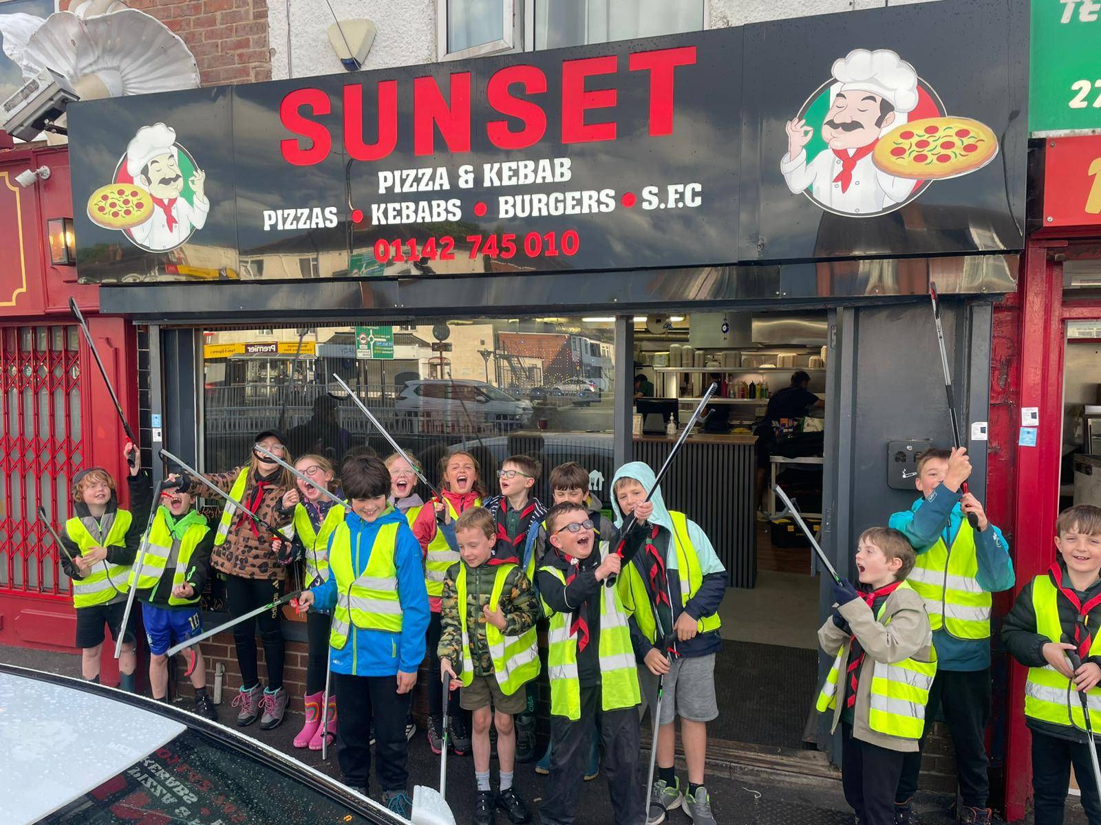 Cubs out and about with their litter pickers and bags